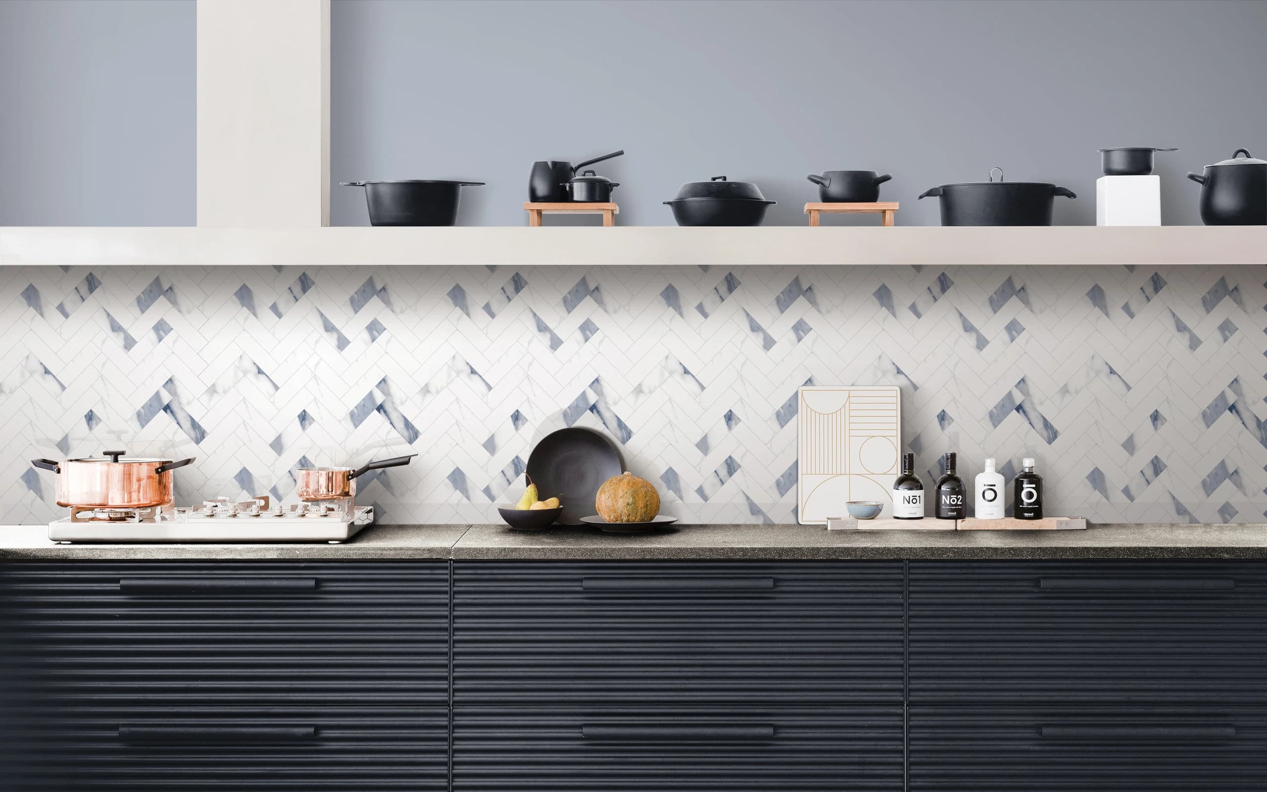 Statement kitchen backsplash — blue herringbone tile